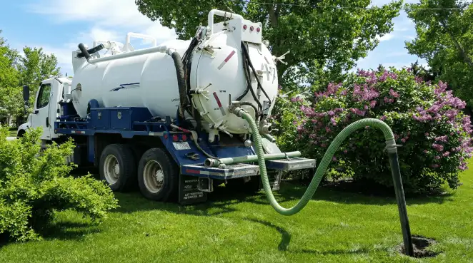 Professional vacuum truck performing residential drainage and septic maintenance in Mesa, AZ