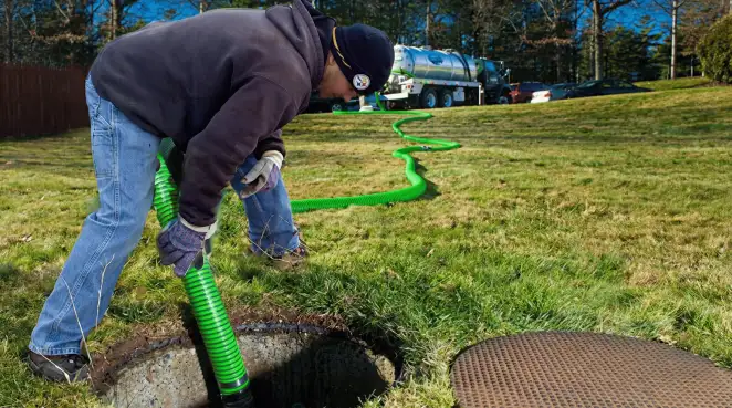 Service technician performing residential septic pumping and drainage maintenance in Mesa, AZ